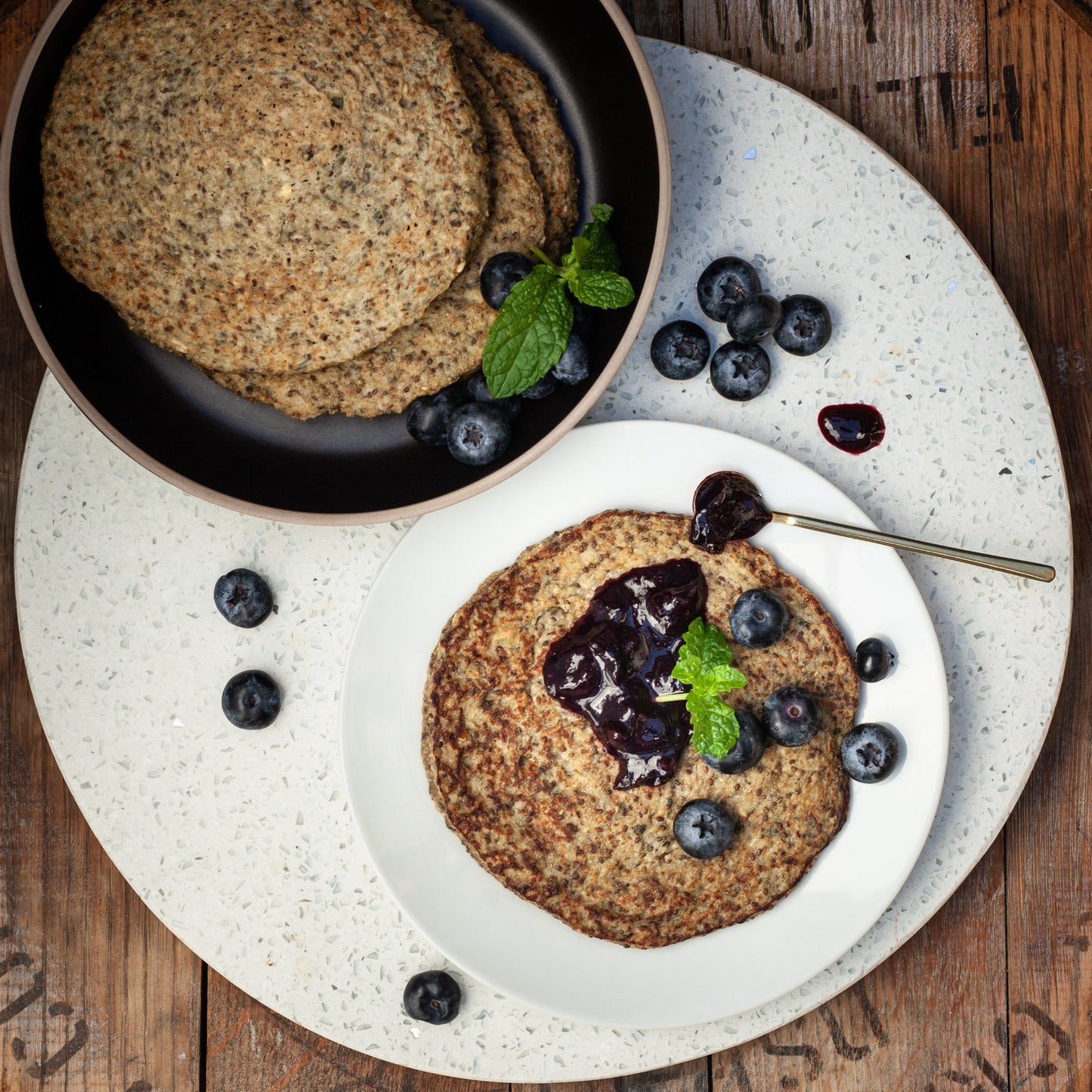 Ready to eat vegan protein flapjacks served with blueberry puree.